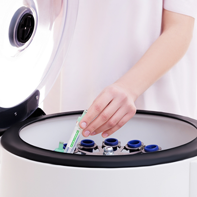 Doctor placing a blood sample in a device filled with other blood samples