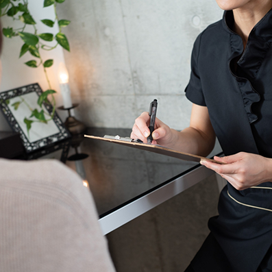 Patient filling out paperwork on a clipboard