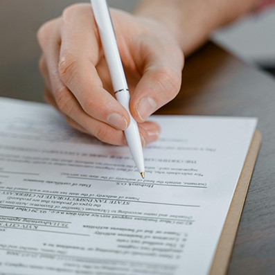 Close up of a person filling out paperwork