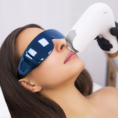 Woman having an aesthetic doctor hold a laser device to her face